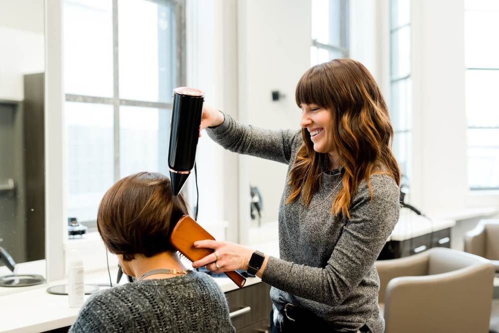 A hairdresser styling a client's hair